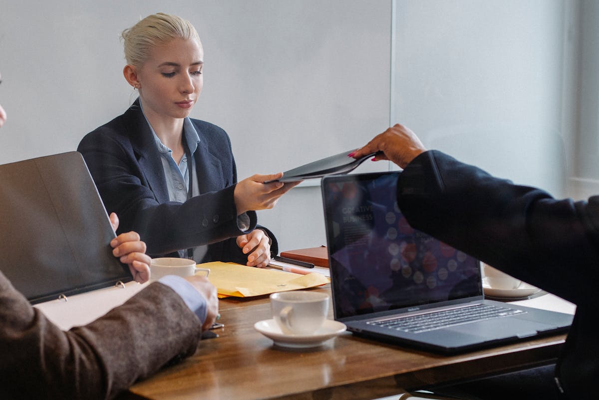 Multiracial businesspeople discussing new business project while using laptop