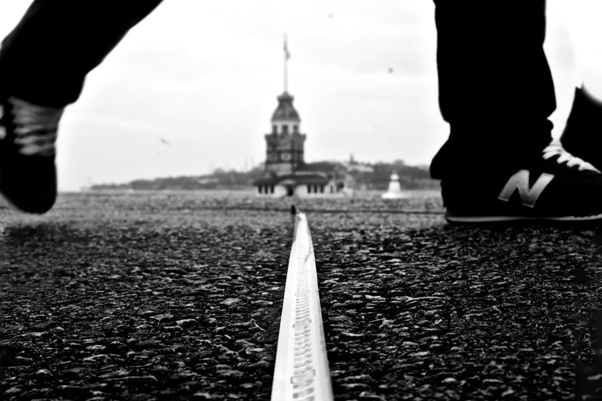 Close-up of Man Crossing Border on Ground