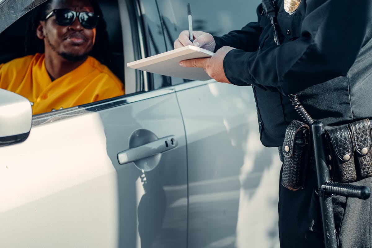 Man Looking at the Police Officer Writing