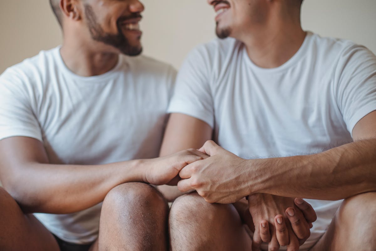 Men Sitting Together Holding Hands